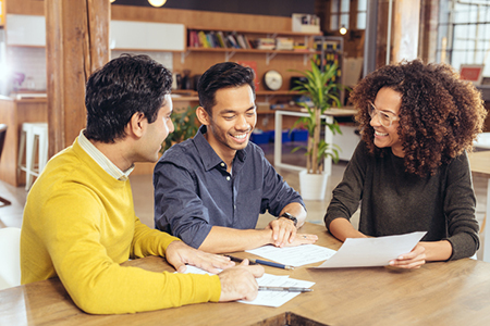 A couple meeting with a real estate agent to help them sell their home as-is